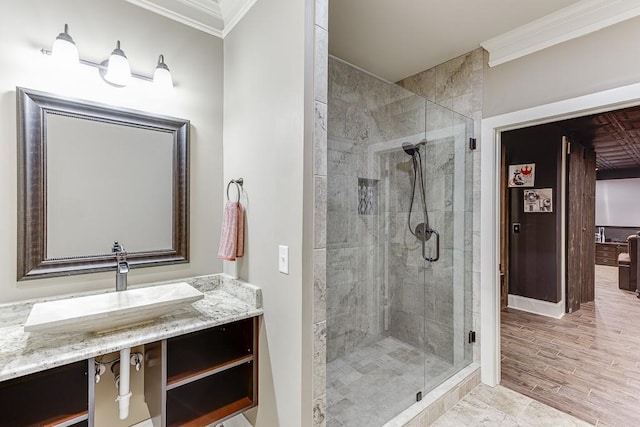 bathroom featuring an enclosed shower, vanity, and crown molding