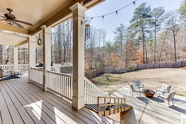 deck with an outdoor fire pit and ceiling fan