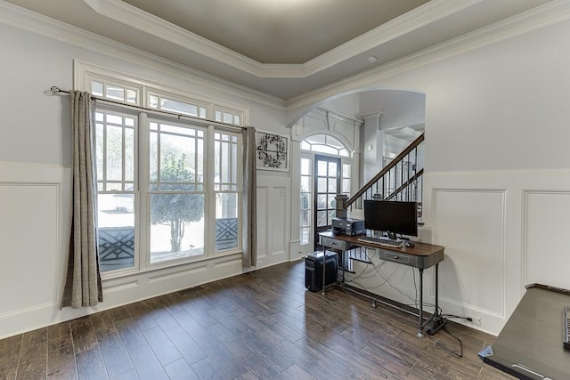 entryway featuring dark wood-type flooring, crown molding, and a raised ceiling