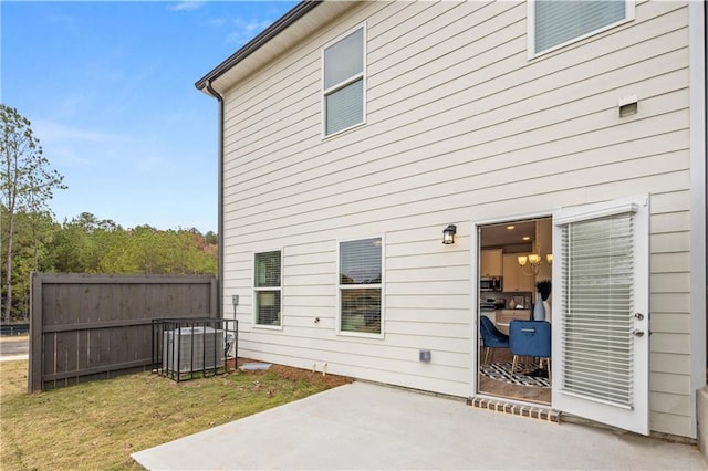 rear view of property featuring a patio and a lawn