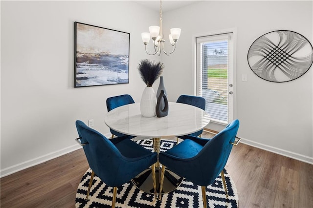 dining space with an inviting chandelier and dark hardwood / wood-style floors