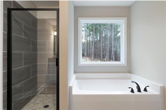 bathroom featuring separate shower and tub