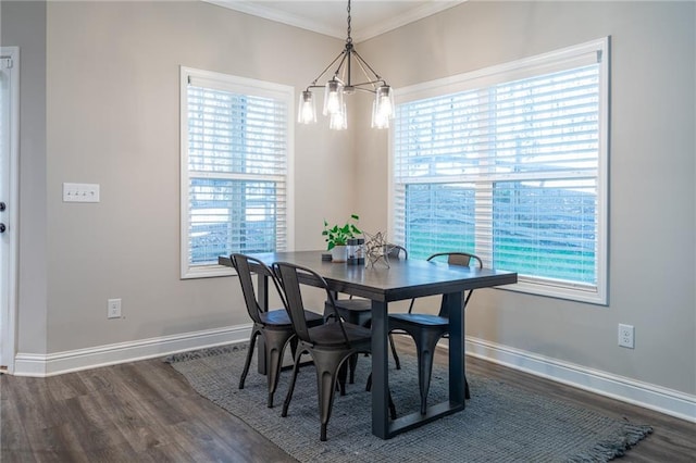 dining room featuring dark wood-type flooring, plenty of natural light, and ornamental molding