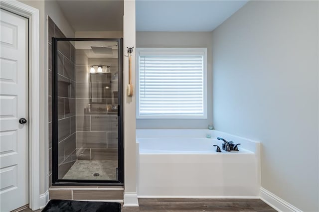 bathroom with plus walk in shower and wood-type flooring