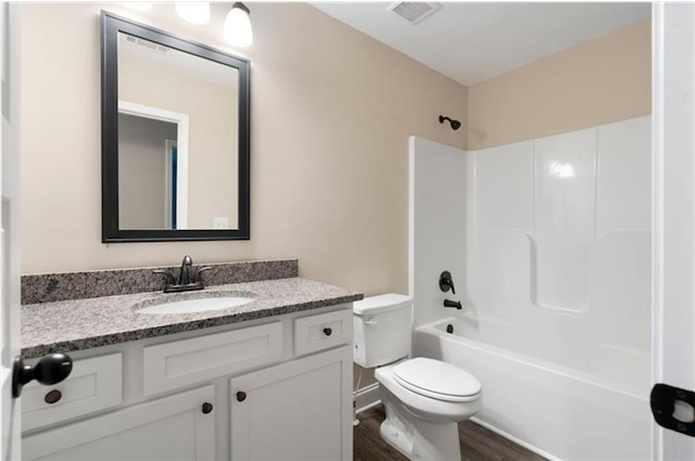 full bathroom featuring vanity, hardwood / wood-style flooring, toilet, and tub / shower combination