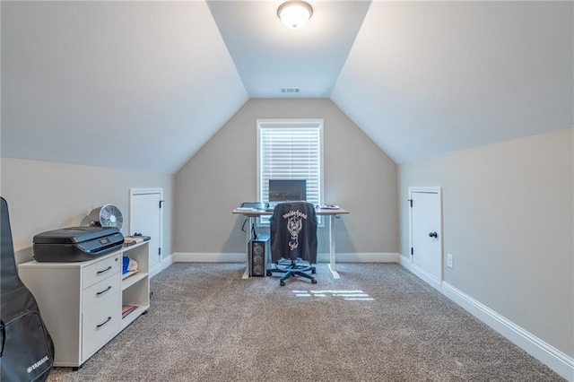 carpeted office featuring vaulted ceiling