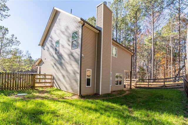 rear view of property featuring a yard