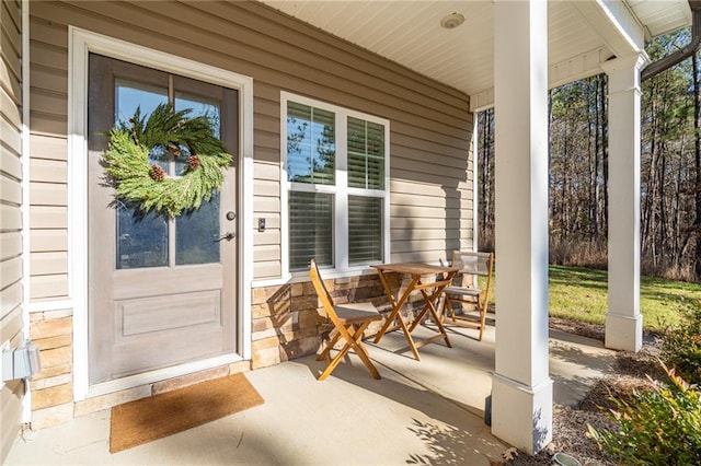 view of exterior entry with a porch