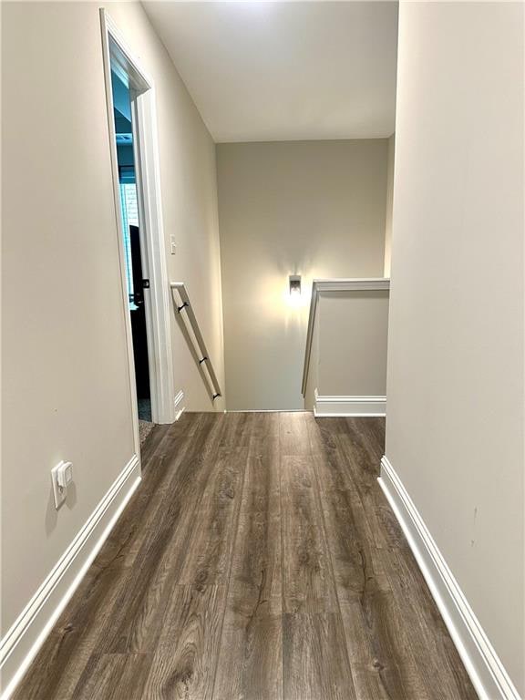 hallway with dark hardwood / wood-style flooring