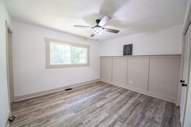 178 Wayne St SW, Calhoun, GA 30701 - empty room featuring wood finished floors, ceiling fan, a textured ceiling, and baseboards