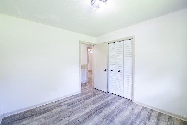 178 Wayne St SW, Calhoun, GA 30701 - unfurnished bedroom featuring wood finished floors, a closet, and baseboards