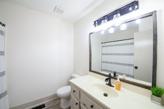178 Wayne St SW, Calhoun, GA 30701 - full bathroom featuring wood finished floors, toilet, vanity, and baseboards