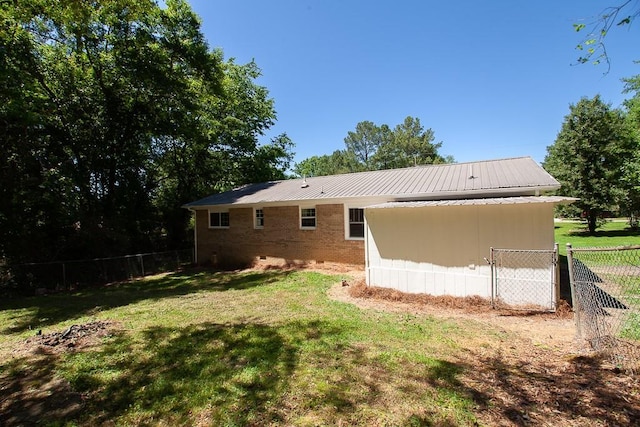 178 Wayne St SW, Calhoun, GA 30701 - rear view of property featuring brick siding, metal roof, and crawl space
