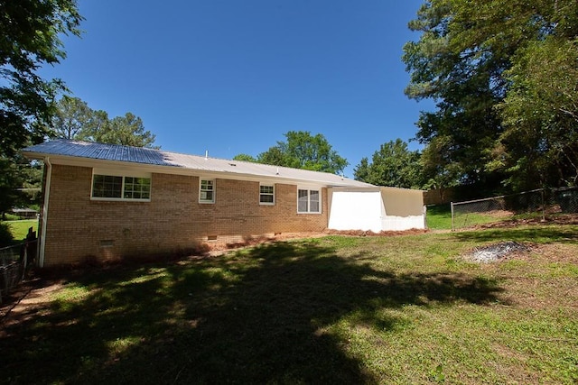 178 Wayne St SW, Calhoun, GA 30701 - back of property with crawl space, metal roof, and brick siding