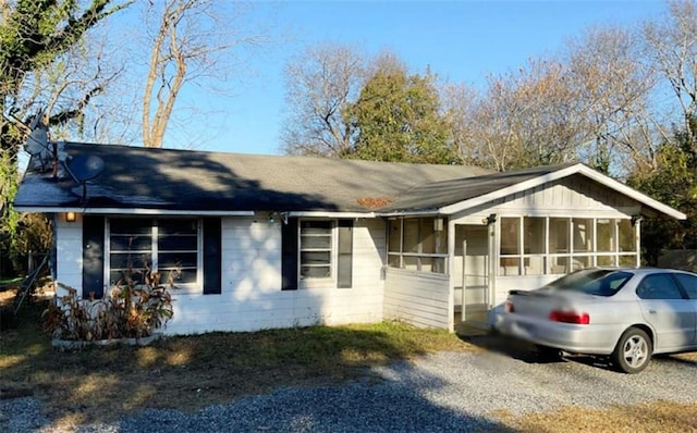 single story home featuring a sunroom