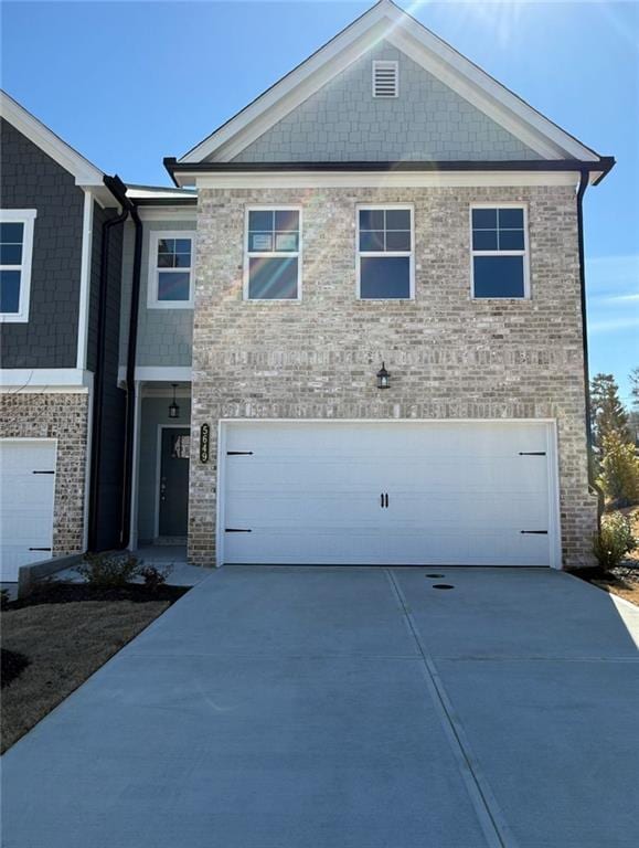 5649 Hislop Ln Unit 90, Mableton, GA 30126 - view of front of home featuring concrete driveway, an attached garage, and brick siding