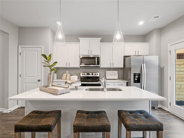 5649 Hislop Ln Unit 90, Mableton, GA 30126 - kitchen with appliances with stainless steel finishes, a sink, dark wood-style flooring, a breakfast bar area, and recessed lighting
