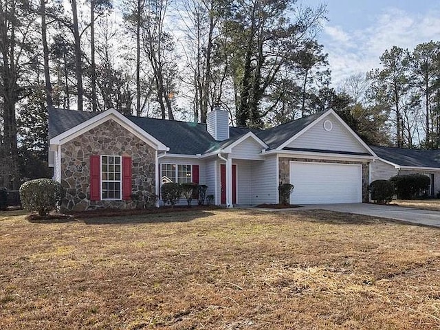 ranch-style home featuring stone siding, concrete driveway, an attached garage, and a front yard