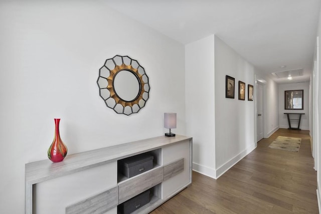 hall with wood finished floors and baseboards