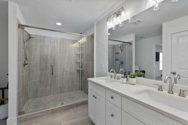 full bathroom with a shower stall, visible vents, and a sink