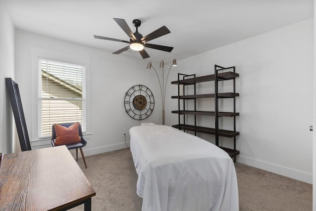 bedroom featuring a ceiling fan, baseboards, and light carpet