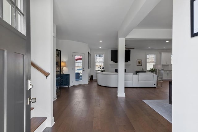 foyer with recessed lighting, a healthy amount of sunlight, dark wood finished floors, and stairs