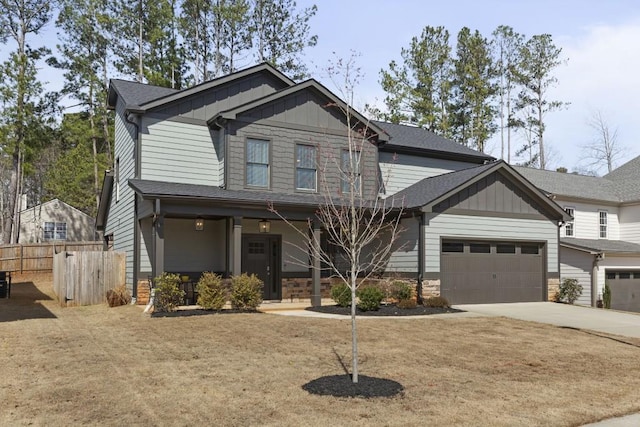 craftsman house with fence, board and batten siding, concrete driveway, a shingled roof, and a garage