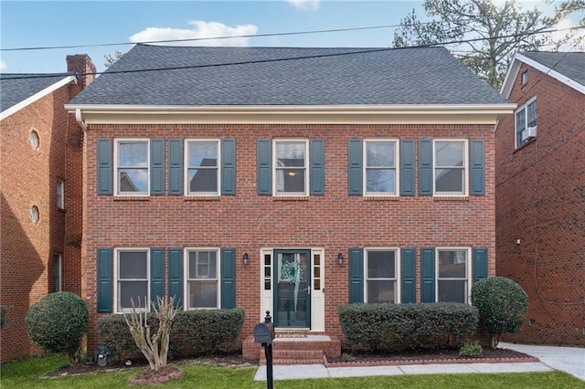 colonial home with a front yard