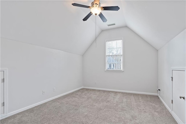 unfurnished living room with ceiling fan with notable chandelier, a towering ceiling, and carpet floors