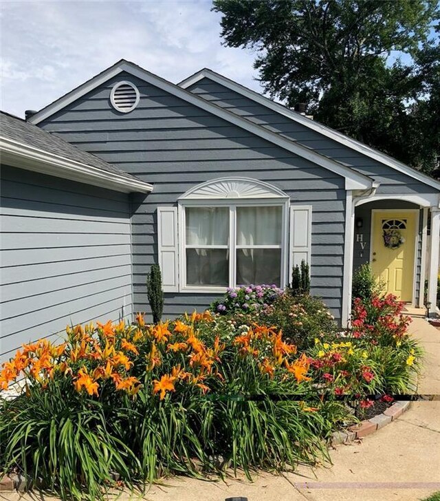 ranch-style house with a garage and a front lawn