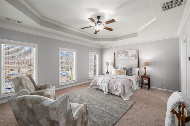 bedroom featuring light colored carpet, a tray ceiling, visible vents, and baseboards