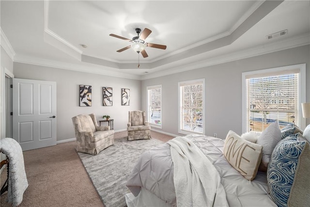 carpeted bedroom with baseboards, visible vents, a raised ceiling, ceiling fan, and crown molding