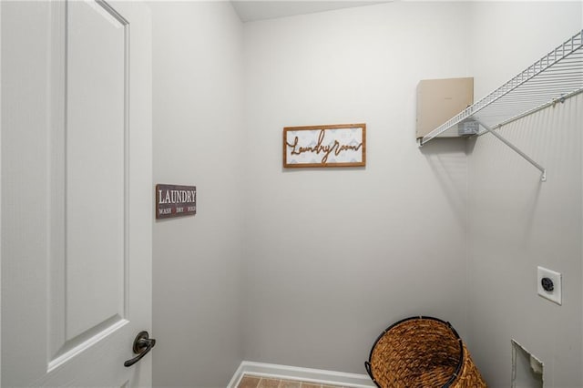 washroom with laundry area, baseboards, and hookup for an electric dryer