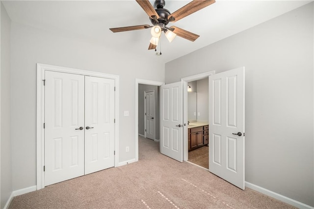 unfurnished bedroom featuring light carpet, ceiling fan, baseboards, and a closet