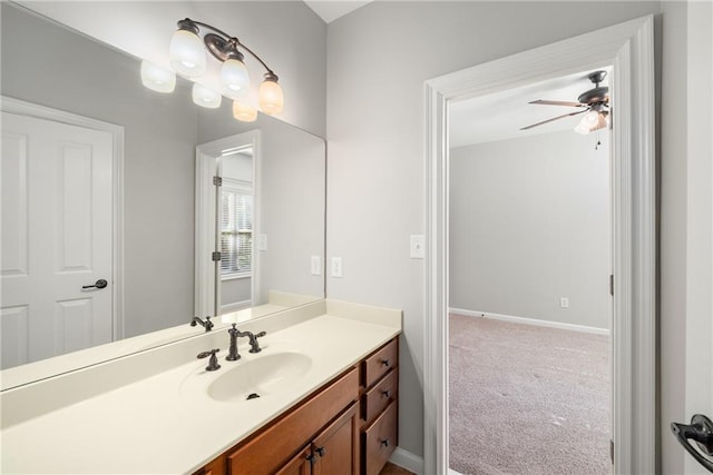 bathroom featuring baseboards, vanity, and a ceiling fan