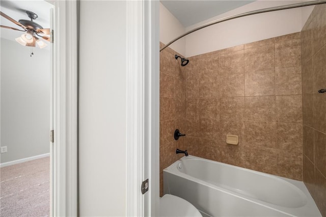 bathroom with a ceiling fan, tub / shower combination, and toilet