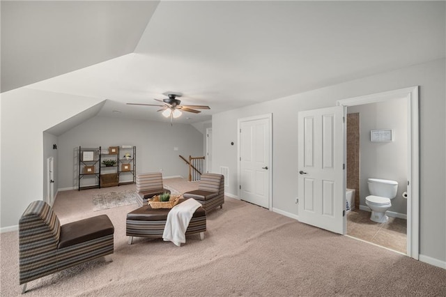 living area with a ceiling fan, lofted ceiling, carpet flooring, and baseboards