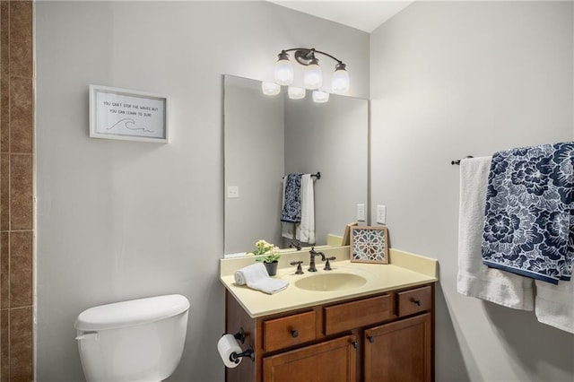 bathroom featuring toilet and vanity