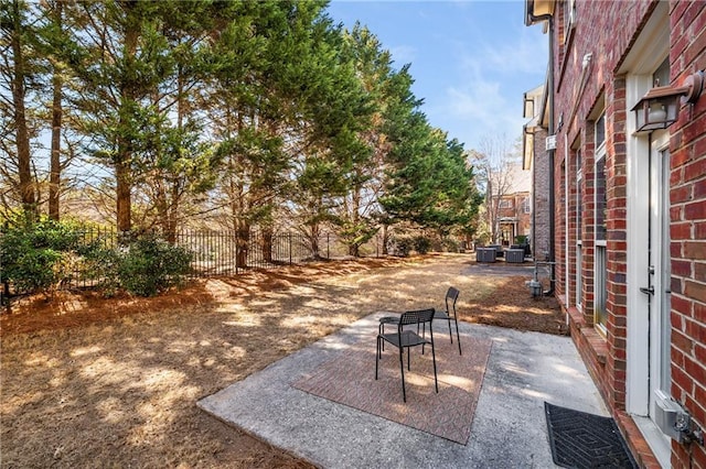 view of patio / terrace with central AC unit and fence