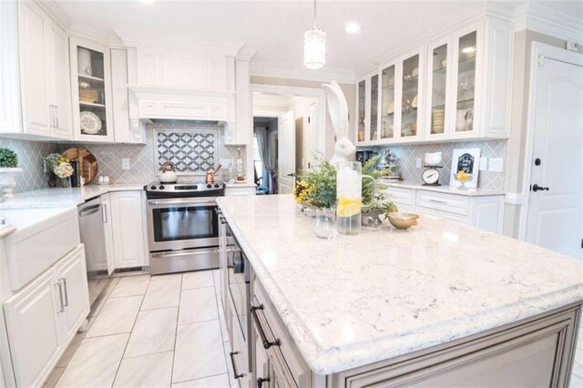 3 Westridge Pl, Rome, GA 30165 - kitchen featuring appliances with stainless steel finishes, decorative light fixtures, white cabinetry, decorative backsplash, and light stone countertops