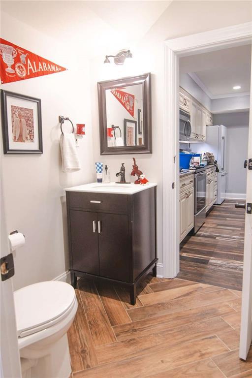 3 Westridge Pl, Rome, GA 30165 - bathroom featuring vanity, crown molding, wood-type flooring, and toilet