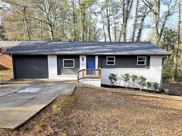 single story home featuring brick siding