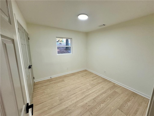 unfurnished bedroom with light wood-type flooring, baseboards, and visible vents