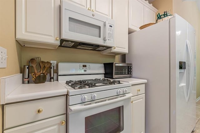 kitchen with white appliances and white cabinets