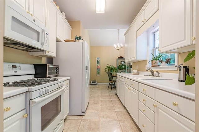 kitchen featuring sink, white cabinetry, decorative light fixtures, light tile patterned floors, and white appliances