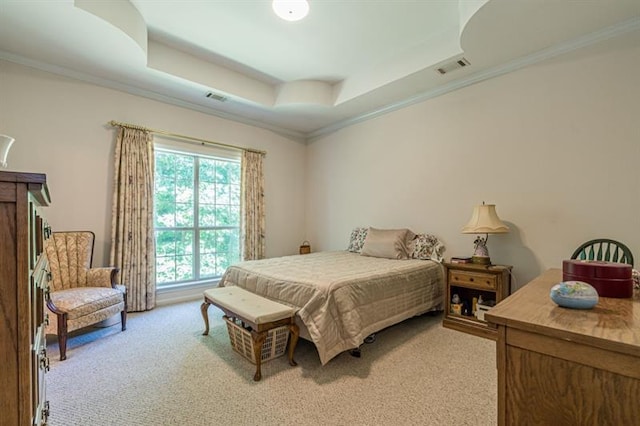 carpeted bedroom with crown molding and a tray ceiling