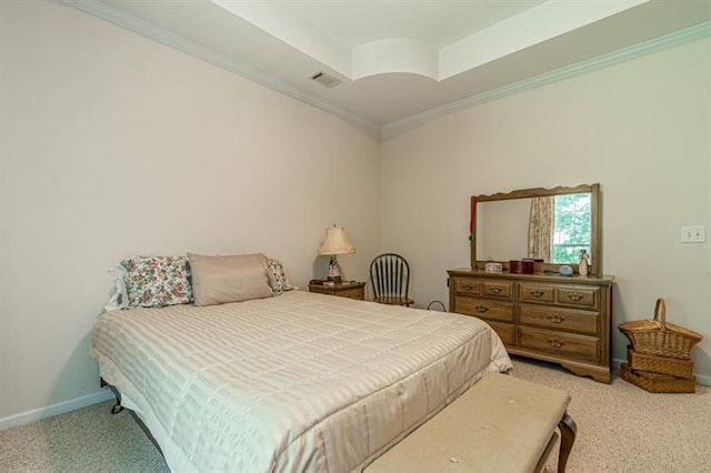 bedroom featuring crown molding, light colored carpet, and a raised ceiling