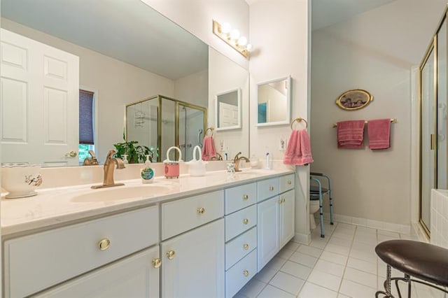 bathroom with tile patterned flooring, vanity, and a shower with shower door