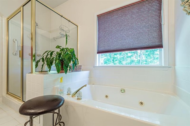 bathroom with tile patterned floors and shower with separate bathtub