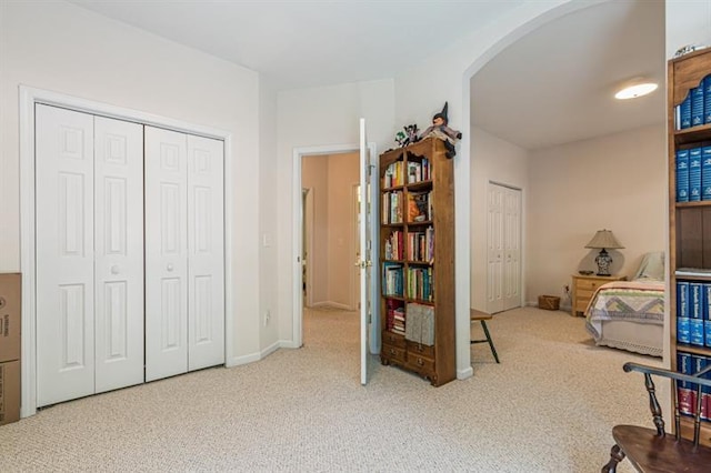 bedroom featuring light carpet